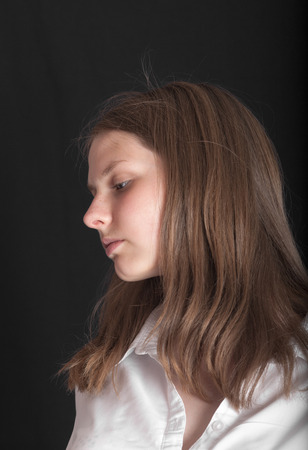 romantic teenager girl in white on black backgroundの写真素材