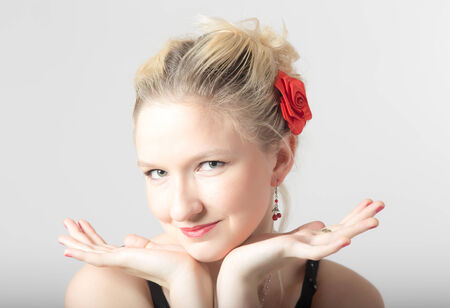 portrait of blonde hair with red roseの写真素材