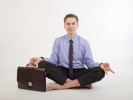 businessman relaxing after work in yoga poseの写真素材