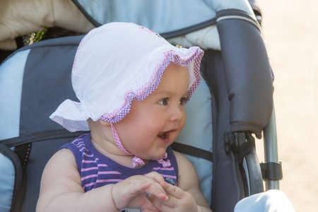 portrait of cheerful baby in a stroller