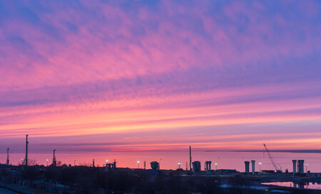 bright sunset over the construction site and the seaの写真素材
