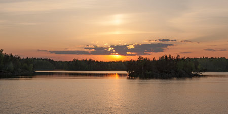 sunset over the lake in the woodsの写真素材