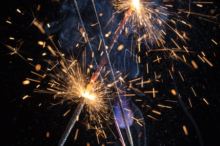 very bright sparklers on black background closeupの写真素材