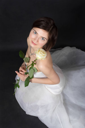 girl in white dress of the bride on a black backgroundの写真素材