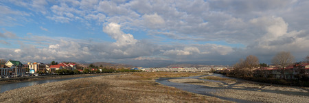 Sochi, Russia - December 15 2014: Adler district with the railway bridge over the river Mzymta