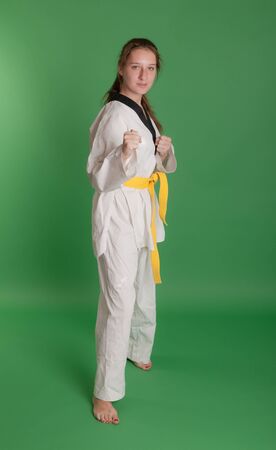 girl in kimono engaged taekwondo, studio shotの写真素材