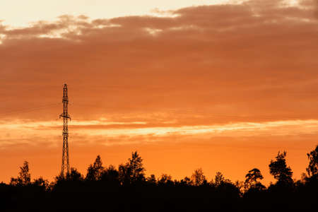 Tower of an electric main against dramatic skyの写真素材