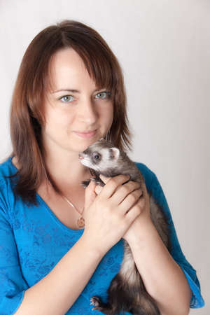 Portrait of the girl with a domestic polecatの写真素材