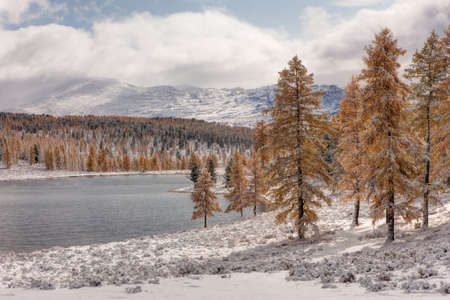 Lake in the mountains after snowfall in autumnの写真素材