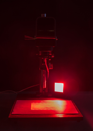 enlarger and red lantern in a dark roomの写真素材