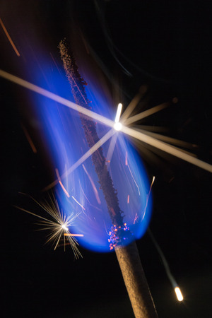 Blue fire with sparks on a black backgroundの写真素材