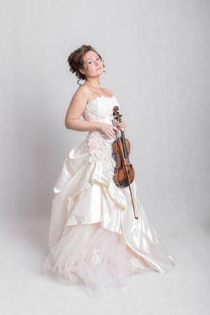girl in a white dress with violinの写真素材