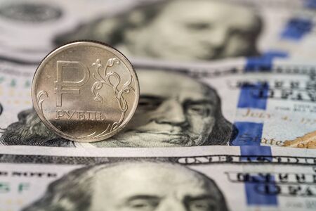one ruble coin on dollars background closeupの写真素材