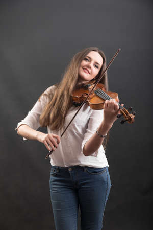 portrait of a beautiful violinist with long hair