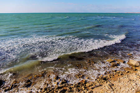 Sea shore with surf in the sunny windy dayの写真素材
