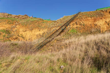 long metal ladder on a steep cliffの写真素材