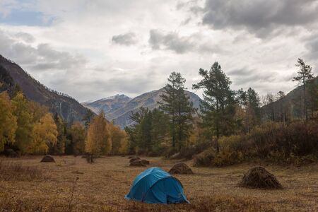 Tourist camp in the autumn mountain valley