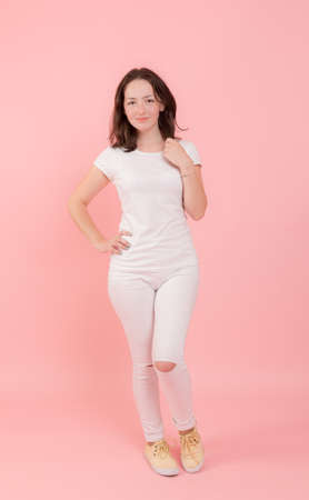 teenager girl in white on a pink backgroundの写真素材