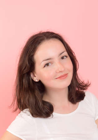 portrait of teenage girl on a pink background
