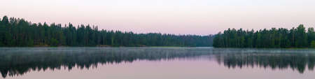 Panorama of forest lake in early summer morningの写真素材