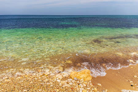 Sea shore with rocks in a sunny dayの写真素材