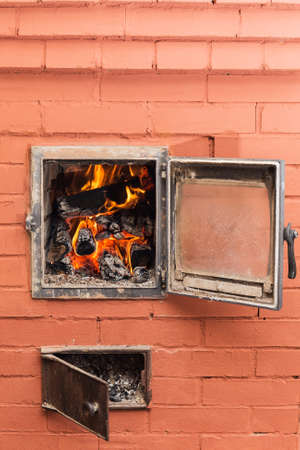 Russian brick oven with fire close up