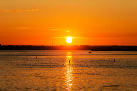 Bright sun at sunset over the seaの写真素材