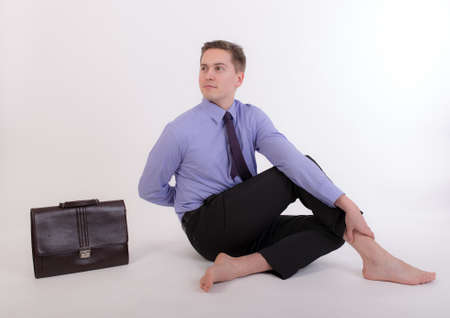 businessman relaxing after work in yoga poseの写真素材