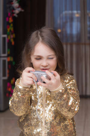 little girl with a camera learns to shootの写真素材
