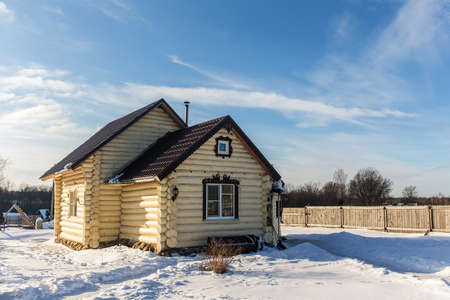 Rural wooden house in a cold winterの写真素材