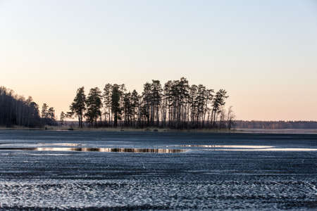 Landscape with melting ice on a spring lake