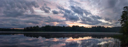 night landscape on a forest lake in summerの写真素材