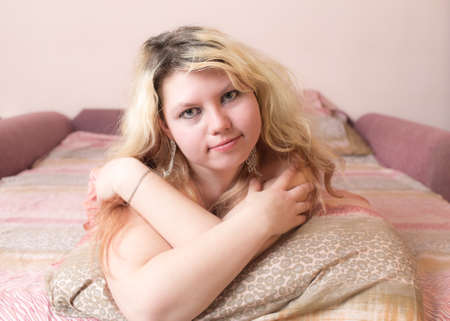 Portrait of a girl on a pillowの写真素材