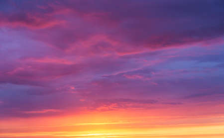 Background of a bright sunset sky with clouds