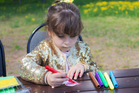 Portrait of a girl drawing colored markersの写真素材