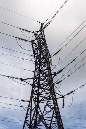Tower power lines against the blue sky