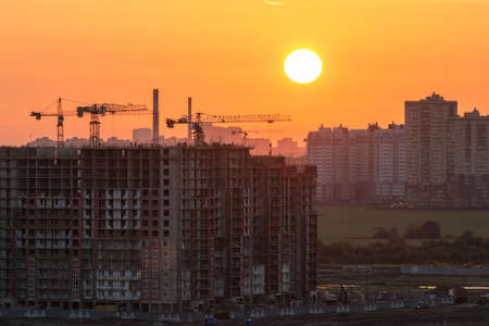 setting sun above the city and the construction siteのeditorial素材