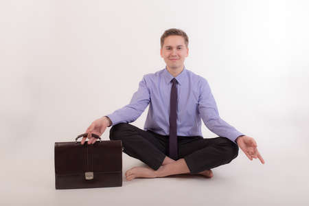 man after work relaxes in a yoga poseの写真素材
