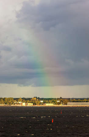 Landscape with a rainbow in the sky over the bayの写真素材