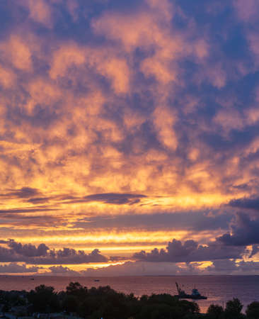 bright sunset with clouds over the seaの写真素材