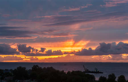 bright sunset with clouds over the seaの写真素材