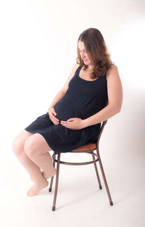 studio portrait of a pregnant woman on a white backgroundの写真素材