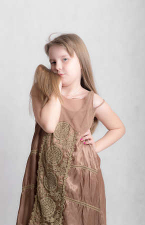 studio portrait of a girl in a brown dressの写真素材
