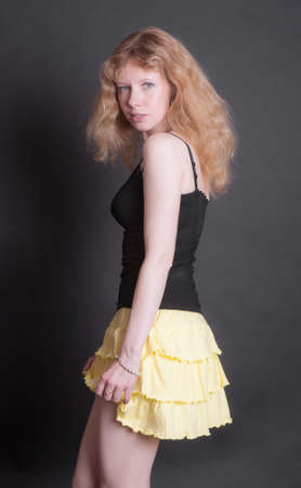 portrait of a slender girl in a yellow skirtの写真素材