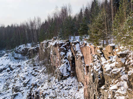 landscape with a winter forest above the cliffsの写真素材