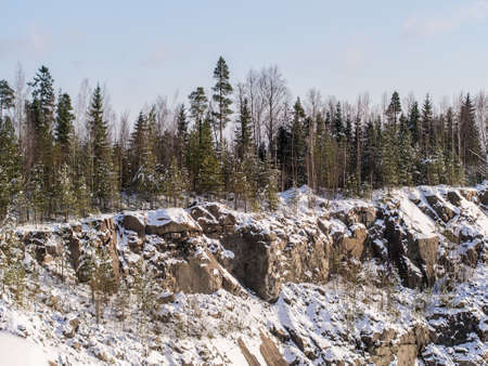 landscape with a winter forest above the cliffsの写真素材