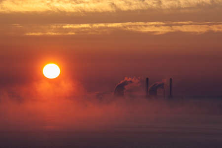 sun at sunset over the sea with fogの写真素材