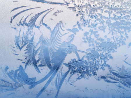 abstract patterns of frost on the glass in winterの写真素材