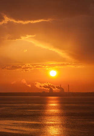 red dramatic sunset with the sun over the seaの写真素材