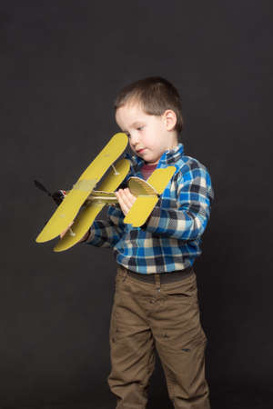 portrait of a little boy with a model airplaneの写真素材